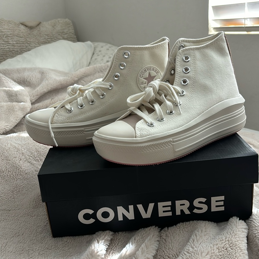 Platform, high top, mauve and cream Converse shoes.